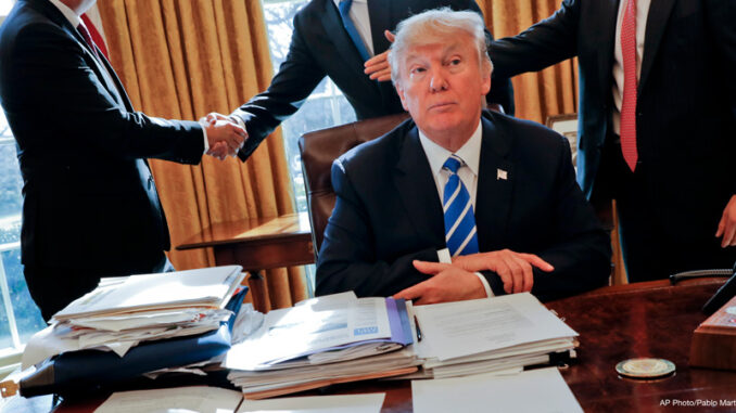 050217_03_FS President Donald Trump sits at his desk after a meeting