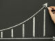 Sketching growth chart on blackboard