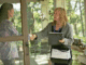 US Census taker greeting resident at the front door with a handshake.