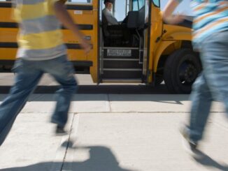 Schoolchildren running to school bus