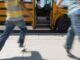 Schoolchildren running to school bus