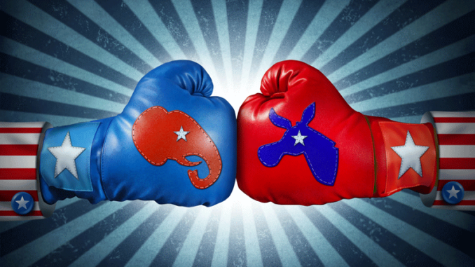 11317_03_IS Republican versus Democrat. Close-up view of two boxing gloves, one with the Republican elephant symbol versus the Democrat donkey symbol, against a starburst background, fighting for the vote of an American election