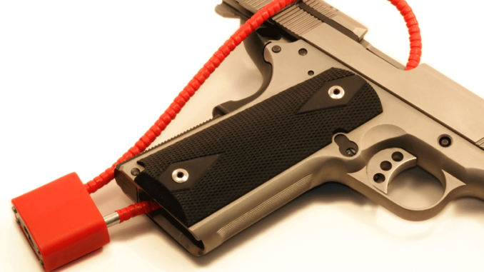 030518_02_IS Close-up cropped view of a red cable lock on a semi-automatic pistol
