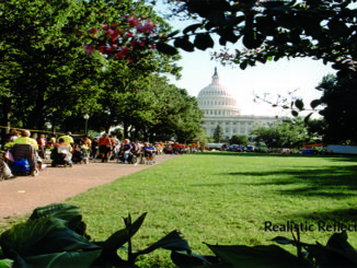 Crowd of people with and without disabilities marching to the Capitol building.