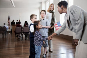 Politician greeting children at political gathering -