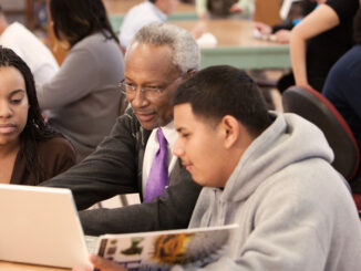 Librarian helping students in school library