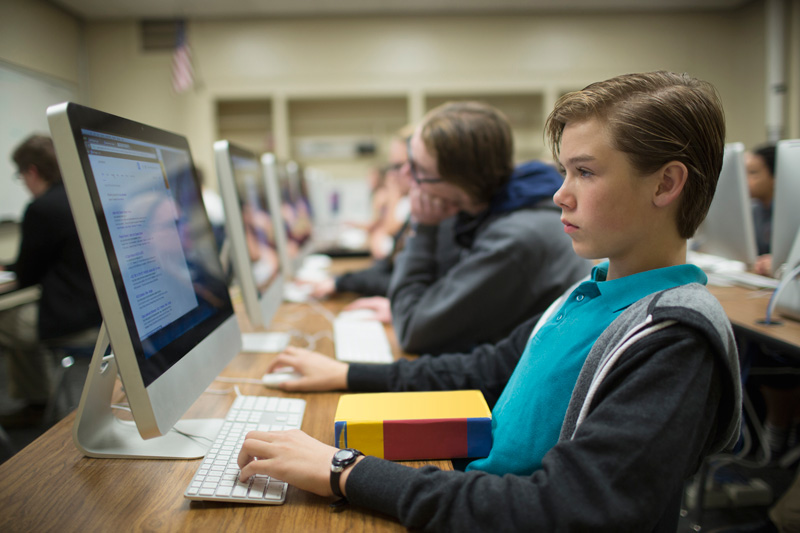 student using computer in classroom