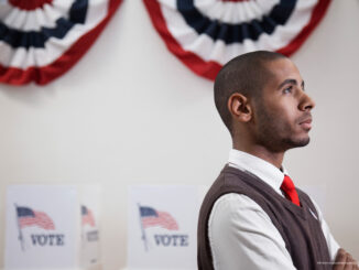 A young voter standing in polling place.