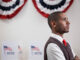 A young voter standing in polling place.