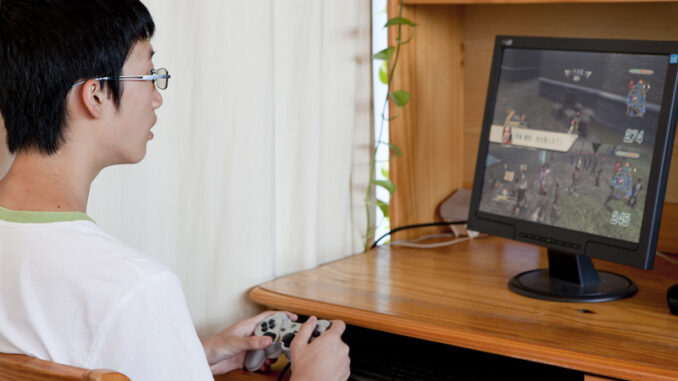 052818_01P_IS teenager playing video game