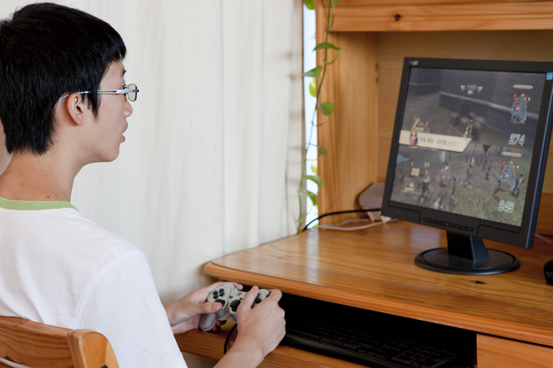 teenager playing video game