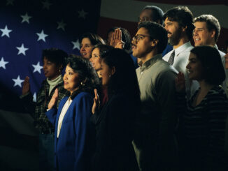 Diverse group being sworn in, American flag in background