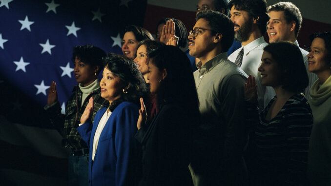 062518_01P_IS Diverse group being sworn in, American flag in background