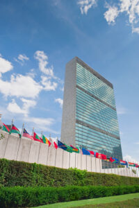 View of the United Nations Secretariat Building rising over the General Assembly Building.