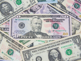 Full-frame view of U.S currency scattered on the table