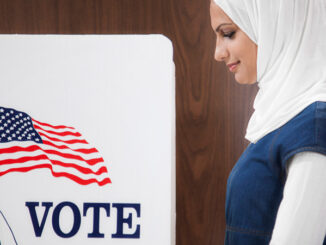 Middle Eastern voter voting in polling place