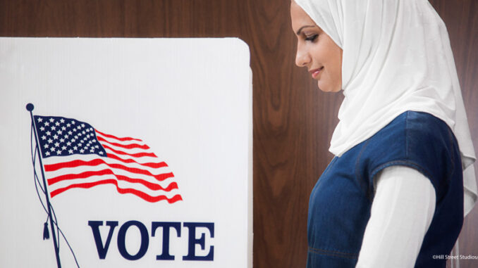 081318_01P_FS Middle Eastern voter voting in polling place