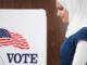 Middle Eastern voter voting in polling place