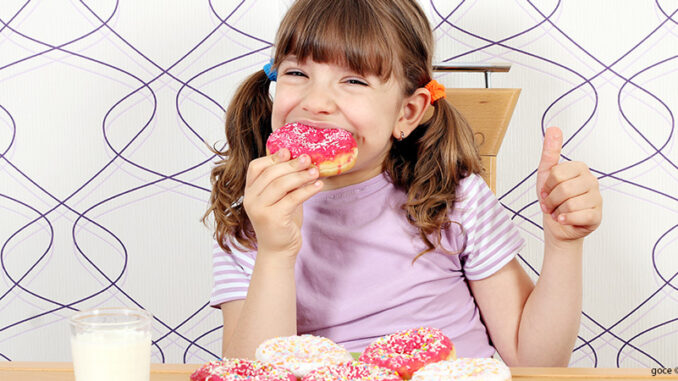 100118_01P_FS hungry little girl eat donuts