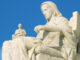 Low angle, side view of Contemplation of Justice by James Earle Fraser on the left of the steps of the United States Supreme Court Building, Washington D.C., USA