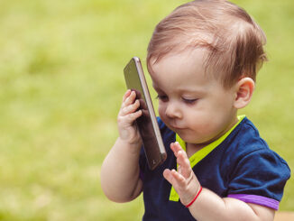 Baby with mobile in park