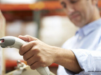 Worker Scanning Package In Warehouse