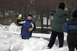 Young boy throwing snowball