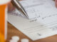 Close up of man filling out prescription