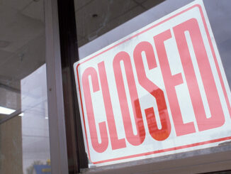 Vacant Department Store With Closed Sign In Window