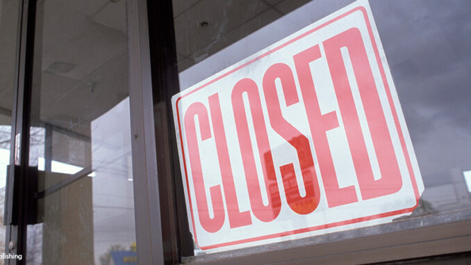Vacant Department Store With Closed Sign In Window