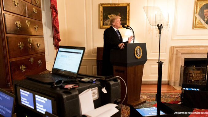 011419_01P_FS President Donald J. Trump, joined by senior White House staff, stands at a podium in the Map Room at the White House, during a prep sessions for President's State of the Union speech, Tuesday, Jan 30, 2018, in Washington, D.C.
