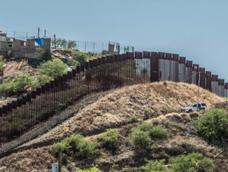 Side view of the border fence separating the United States and Mexico from Nogales, Arizona