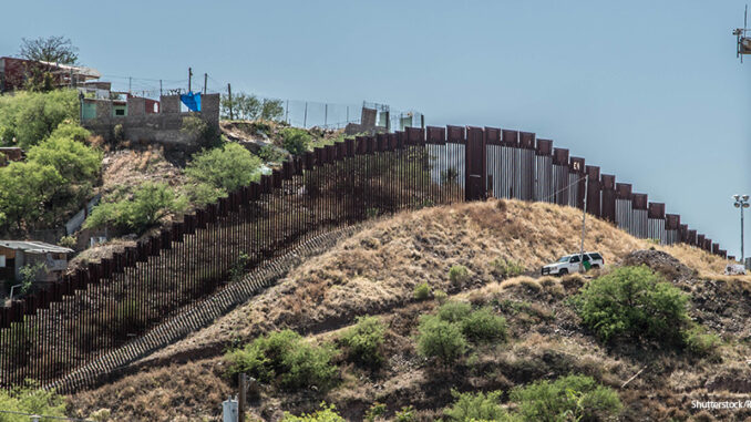 011419_02P_FS Side view of the border fence separating the United States and Mexico from Nogales, Arizona