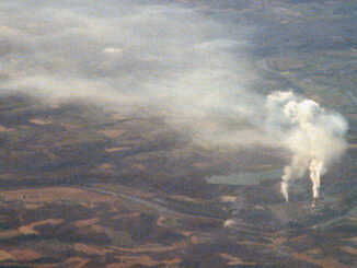 an aerial view of a power plant surrounded by land