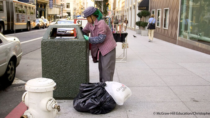 042919_03P_FS Homeless person at public trash can