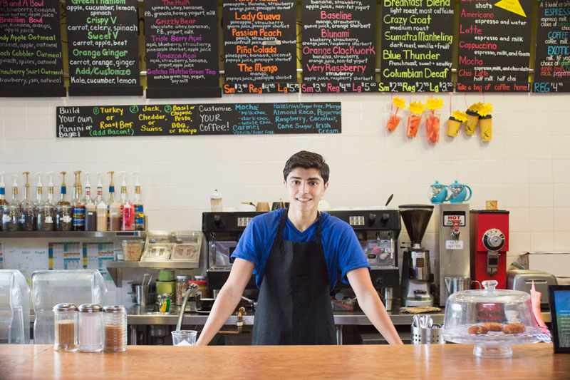 Male working at café counter