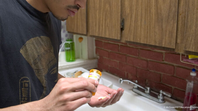 052719_01P_FS Guy taking pills