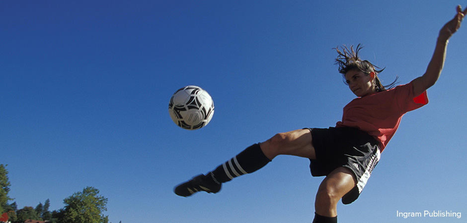 woman kicking soccer ball