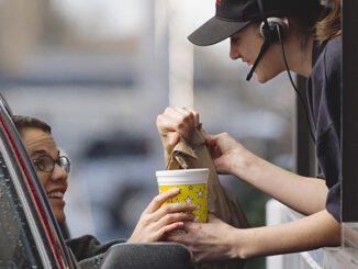 a fast-food employee gives a customer her order