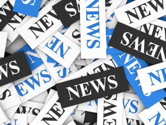 News concept background with a moltitude of signs and text on scattered paper