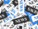 News concept background with a moltitude of signs and text on scattered paper