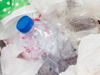 Image of trash bin with waste plastic bottles and bags. Plastic Waste Pollution