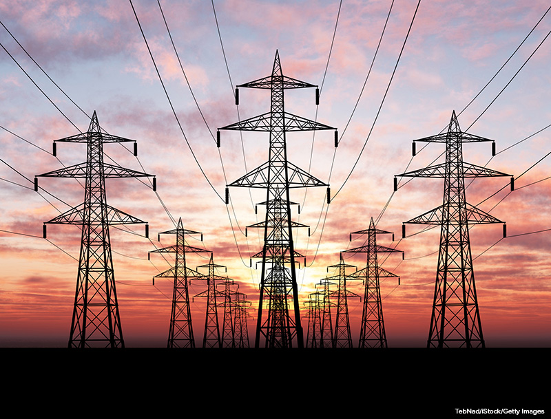 Electric power lines over sunrise