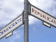 Street sign in crossroad with illustration choice for Democrats and Republicans in US elections.
