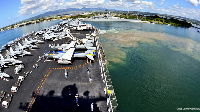 Sailors man the rails aboard the aircraft carrier USS Abraham Lincoln (CVN 72) as the ship departs Pearl Harbor. Sailors man the rails aboard the aircraft carrier USS Abraham Lincoln
