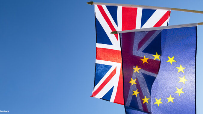 European Union and British Union Jack flag flying in front of bright blue sky in preparation for the Brexit EU referendum Low-angle view of European Union flag and British flag flying in front of bright blue sky