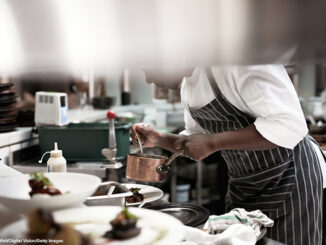 Chef finishing dishes at restaurant