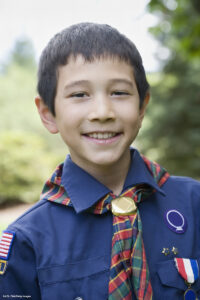 Asian boy wearing Scout uniform