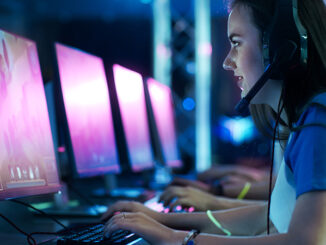 A young woman wearing a headset and playing competivie video games in a tournament.