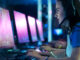 A young woman wearing a headset and playing competivie video games in a tournament.